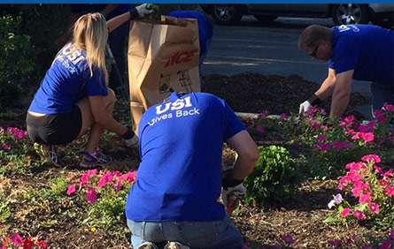 USI employees planting flowers in the community